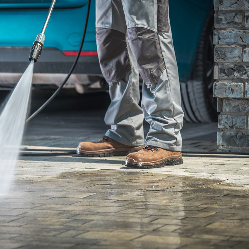 Exterior cleaning image showing paving being pressure washed.