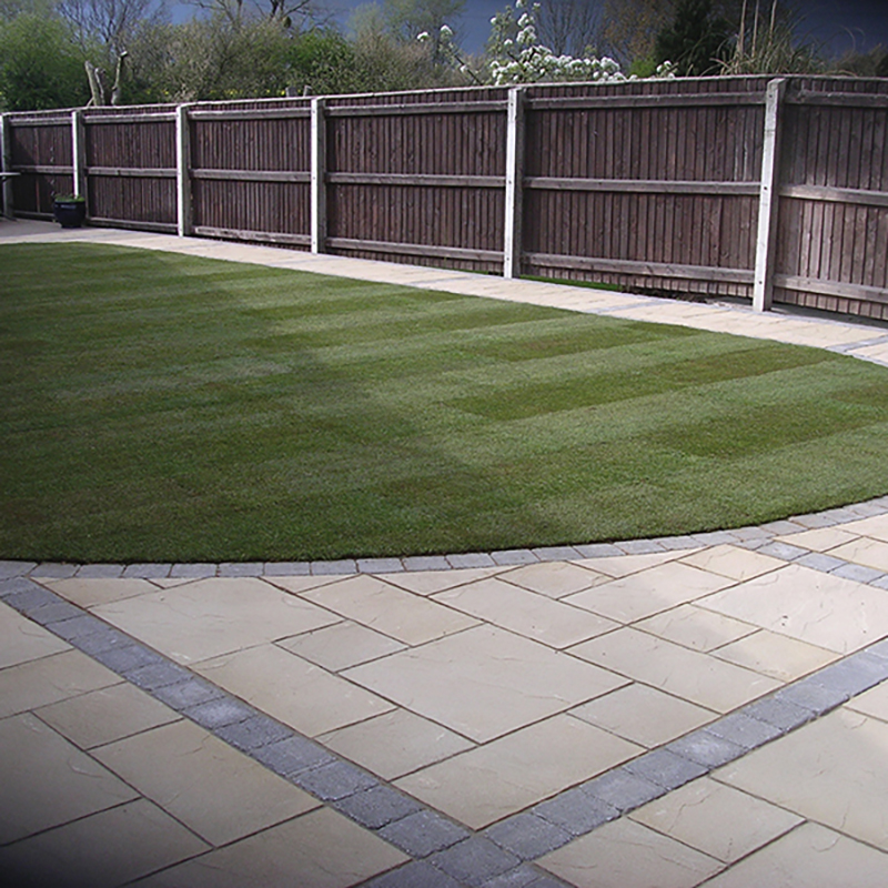 Patio installation image with modern paving and outdoor furniture.